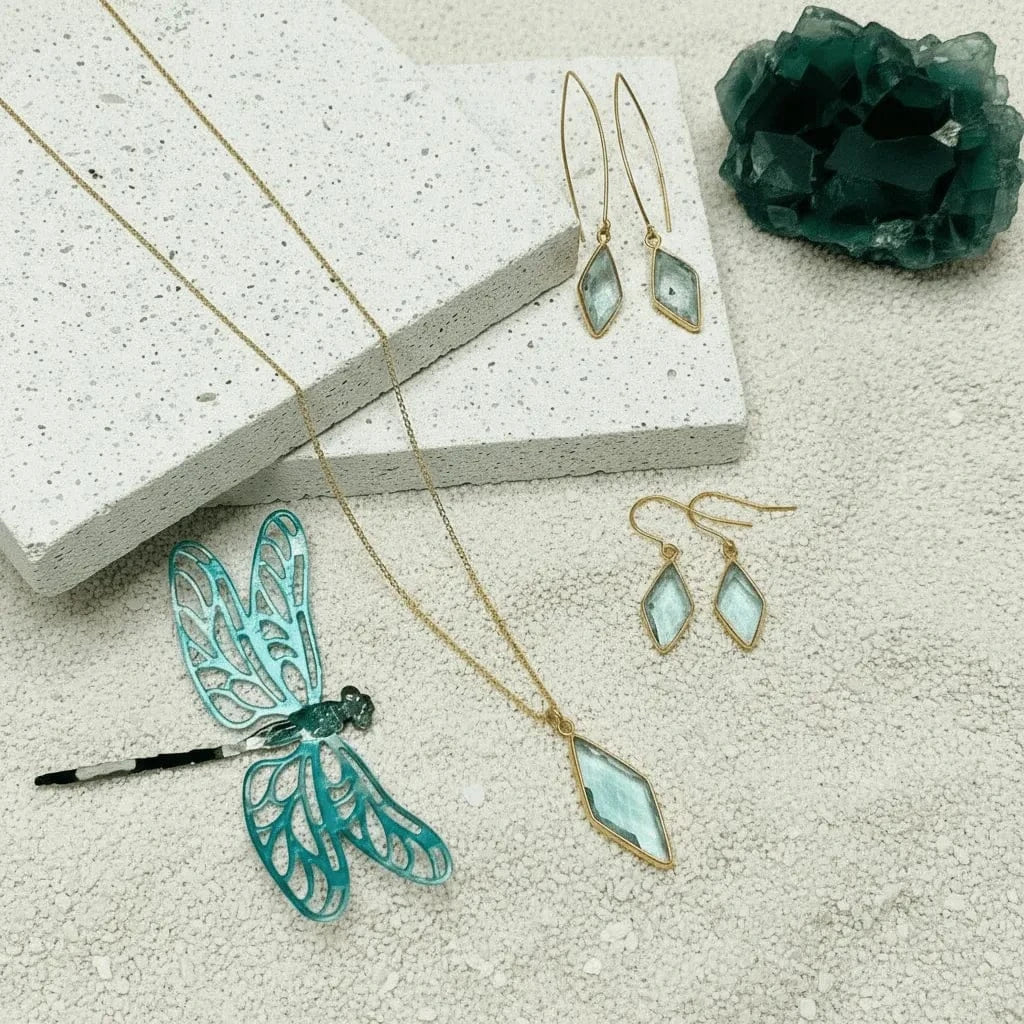 Jewelry set with earrings and a necklace on a textured surface