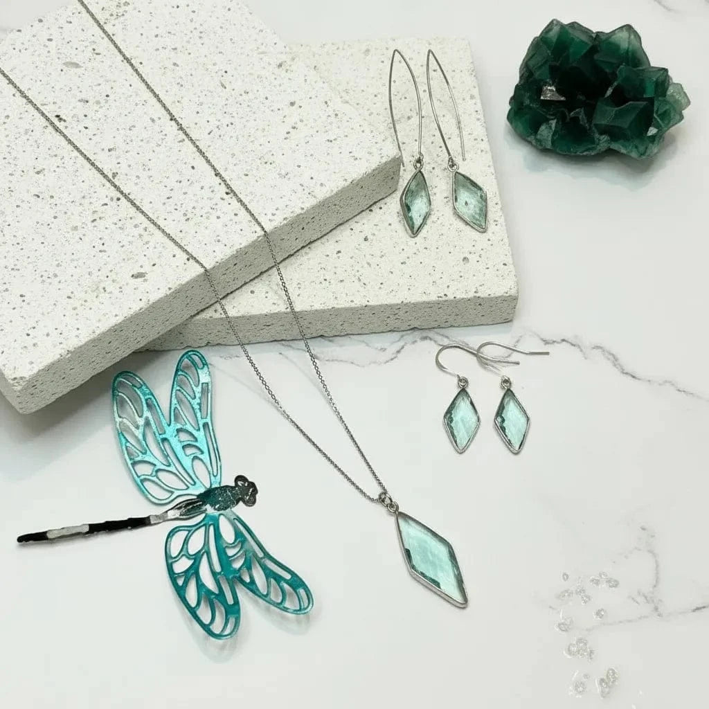 Jewelry set with earrings and a necklace on a textured surface