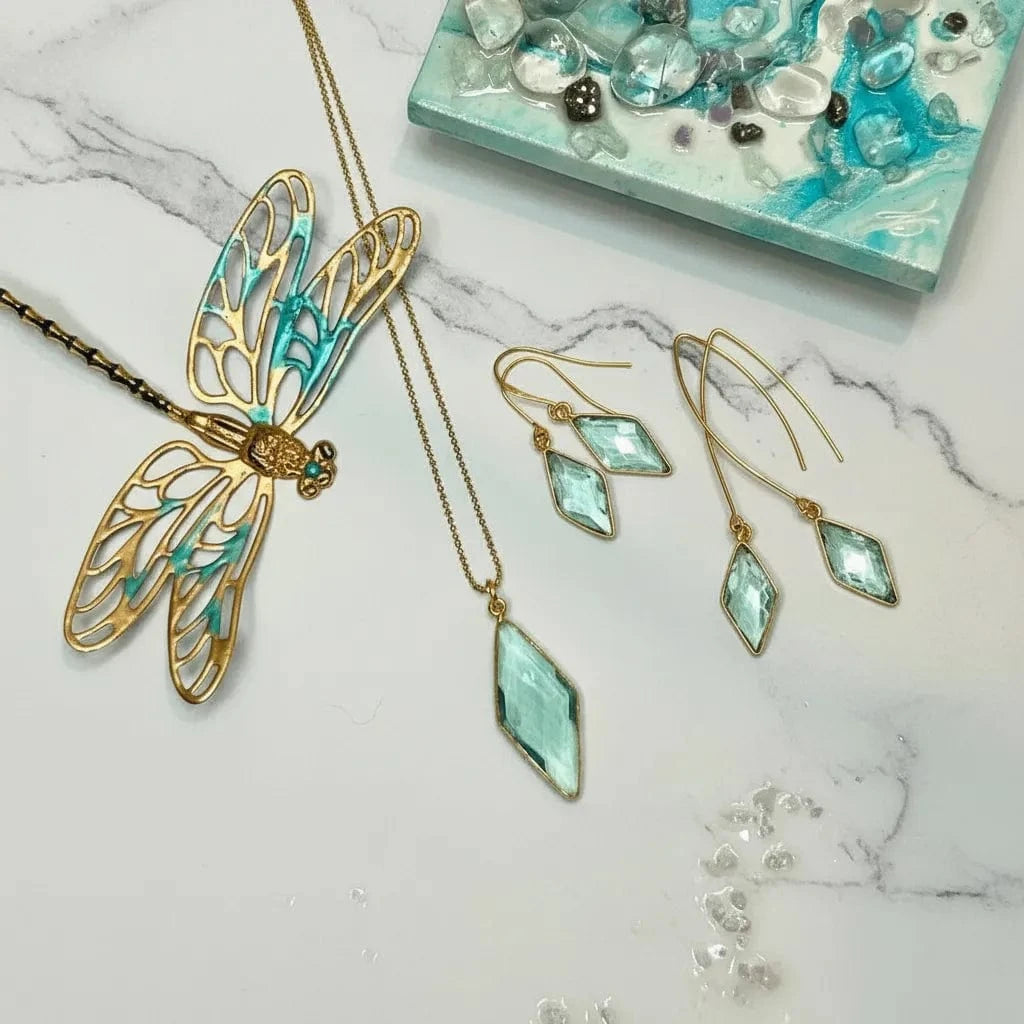 Gold and turquoise jewelry set on a marble surface