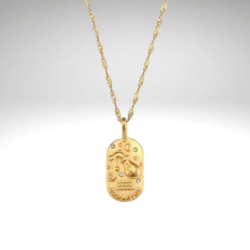 Gold necklace with a pendant on a light gray background
