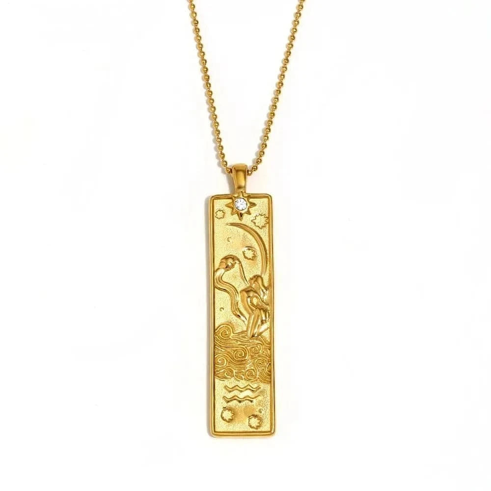 Gold pendant necklace with intricate design on a white background