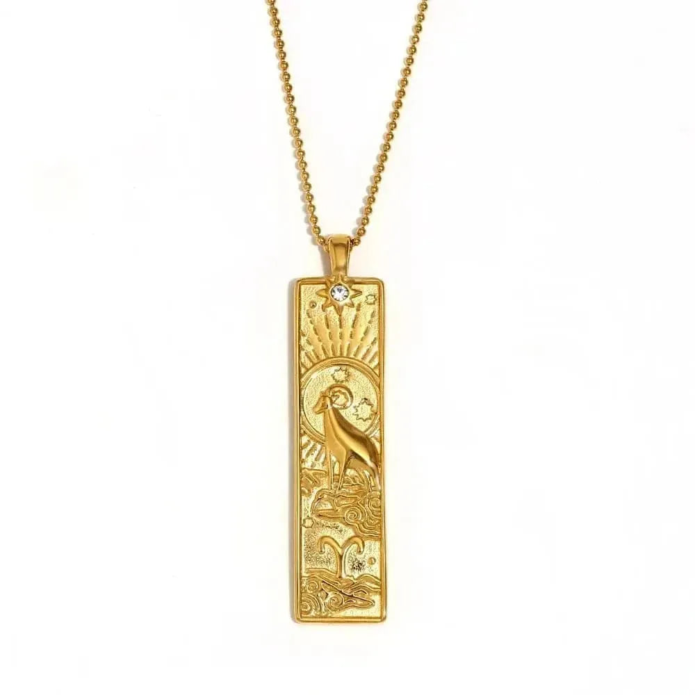 Gold pendant necklace with intricate design on a white background