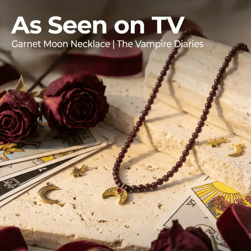 Garnet Moon necklace with dried roses and tarot cards on a textured surface