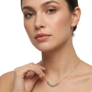 Woman wearing a green aventurine necklace — heart chakra jewelry for growth and new beginnings