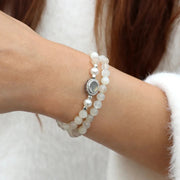 moonstone Pearl bracelet with a silver clasp on a wrist against a neutral background