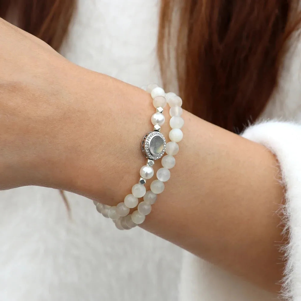 moonstone Pearl bracelet with a silver clasp on a wrist against a neutral background