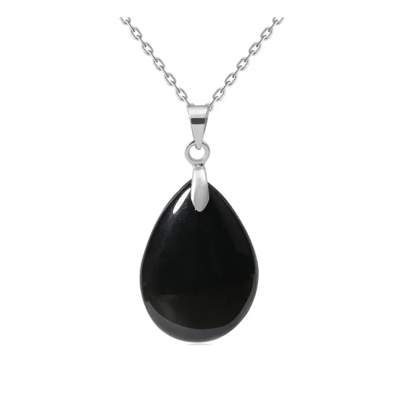 Black teardrop pendant on a silver chain against a white background