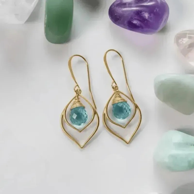 Blue topaz teardrop earrings in gold — December birthstone jewelry for clear communication