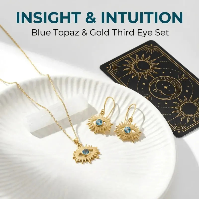 Gold jewelry set with blue stones on a white plate, tarot card in the background, text 'Insight & Intuition'.