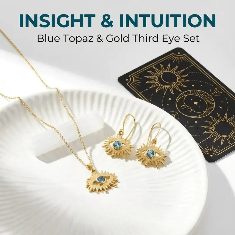 Gold jewelry set with blue stones on a white plate, tarot card in the background, text 'Insight & Intuition'.