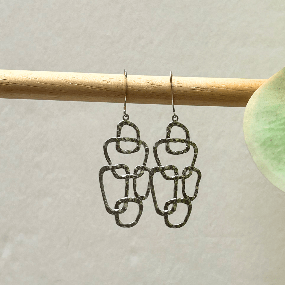Brushed silver earrings on white background