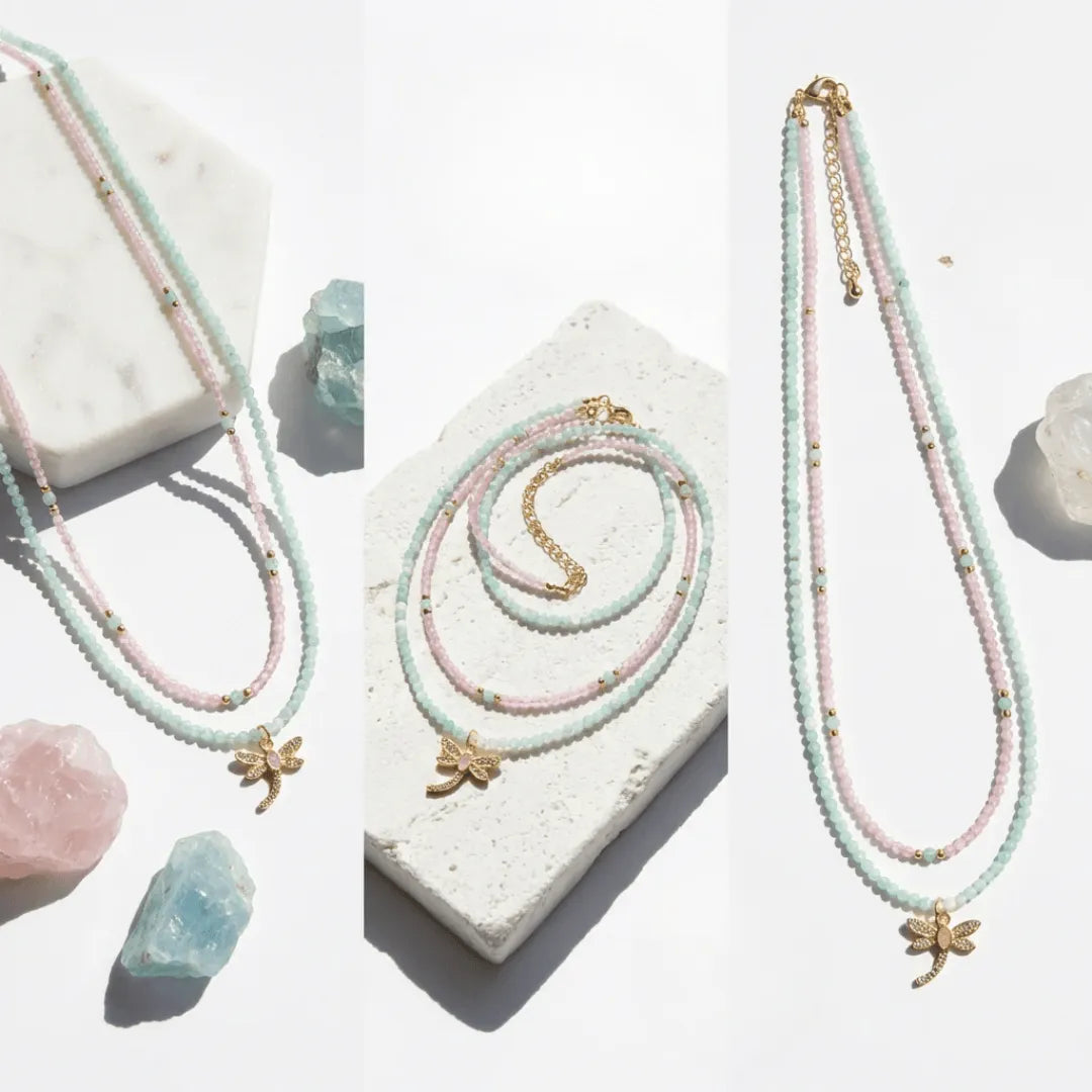 Jewelry set with necklaces and a bracelet on a white surface with crystals.