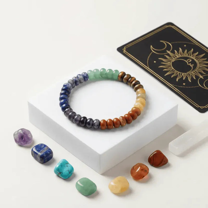 Colorful beaded bracelet on a white stand with stones and a tarot card in the background
