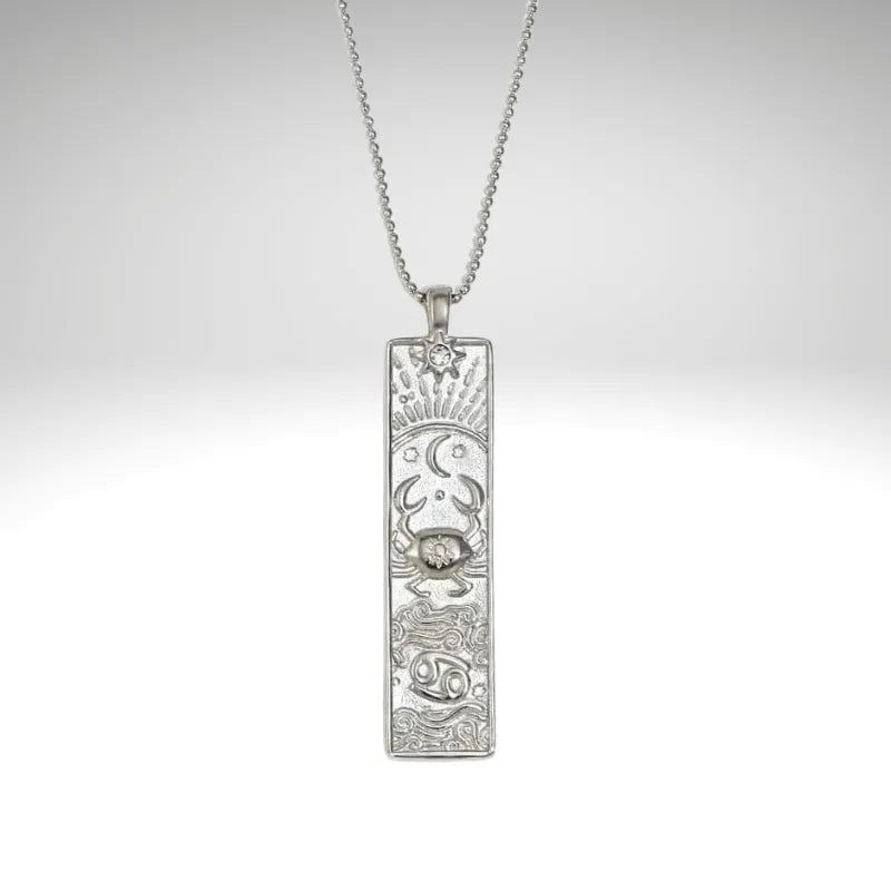 Silver pendant necklace on a light gray background
