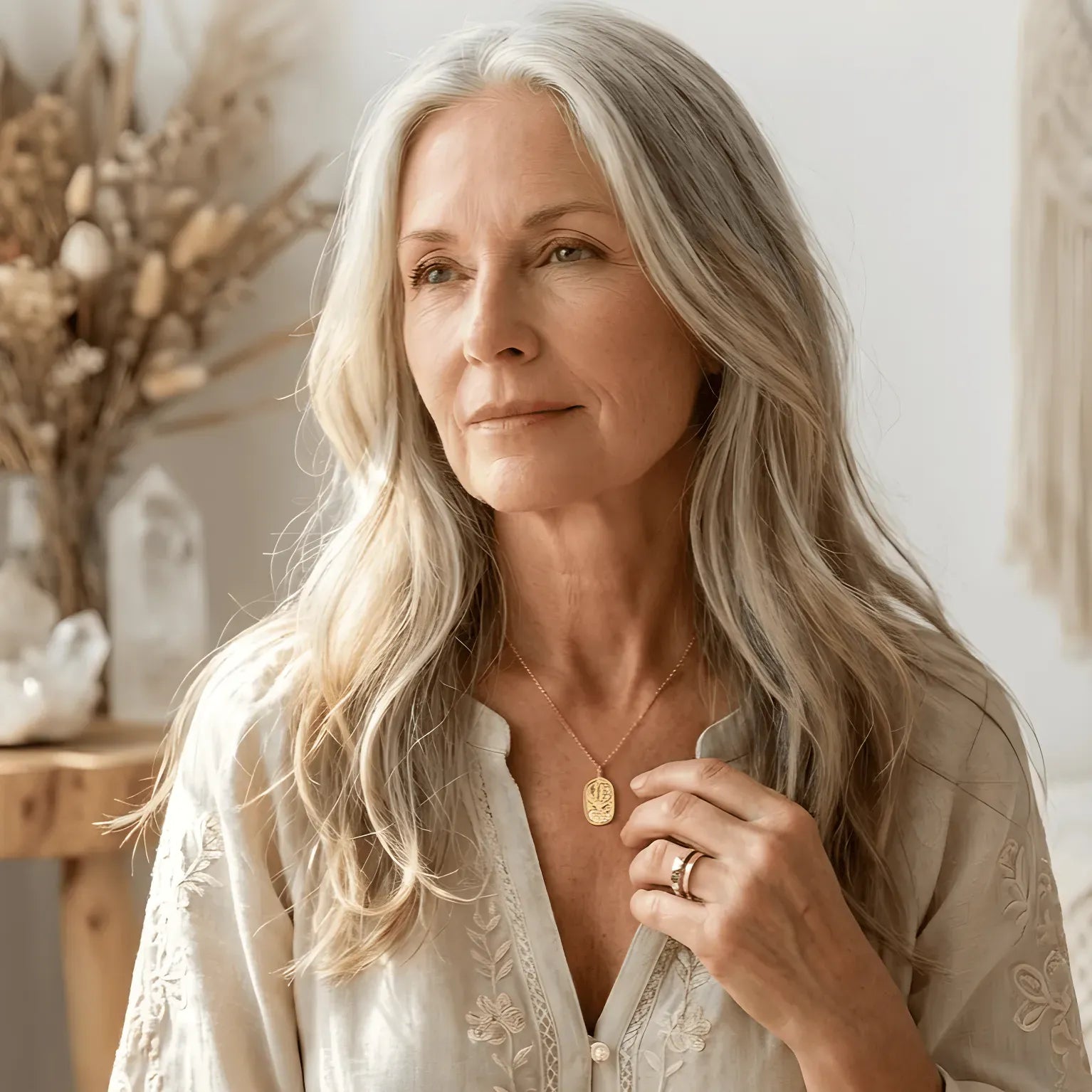 Woman wearing a gold necklace with text about Capricorn season and a call to shop the zodiac collection.