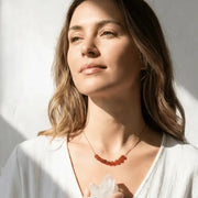 Woman wearing a carnelian sacral chakra necklace — sacral chakra jewelry for creativity