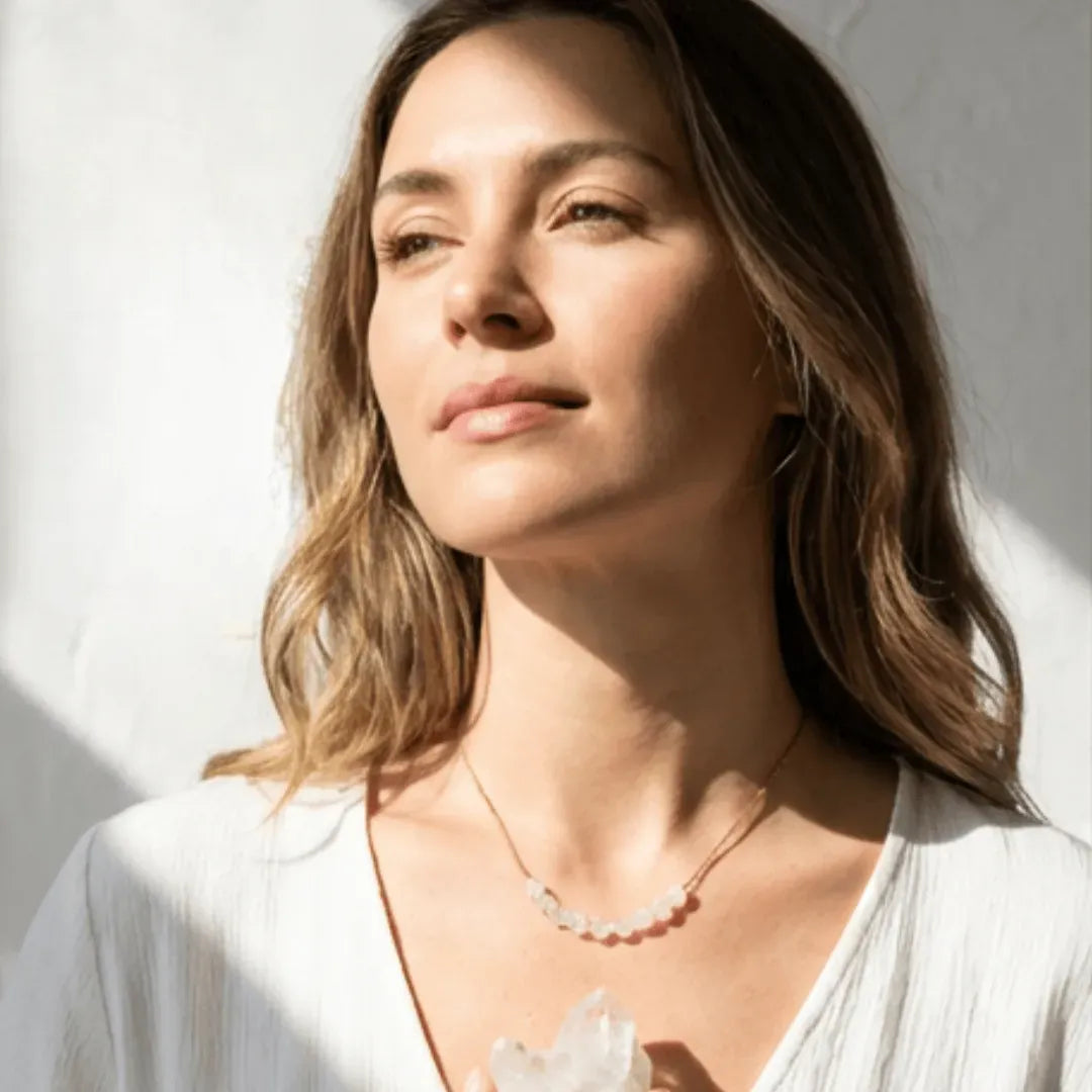 Woman wearing a necklace with a white background