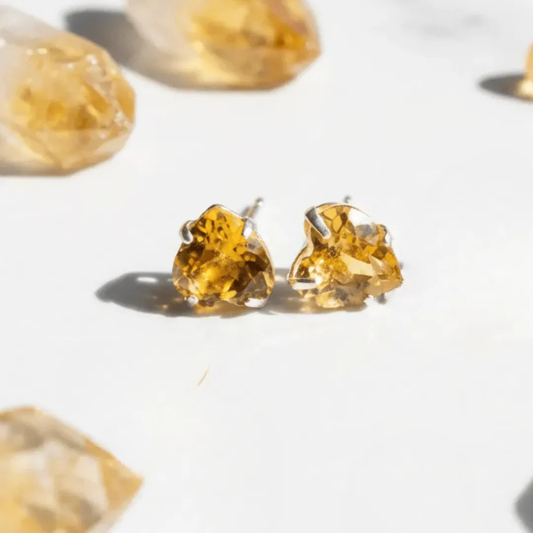 Pair of amber-colored stud earrings on a light background