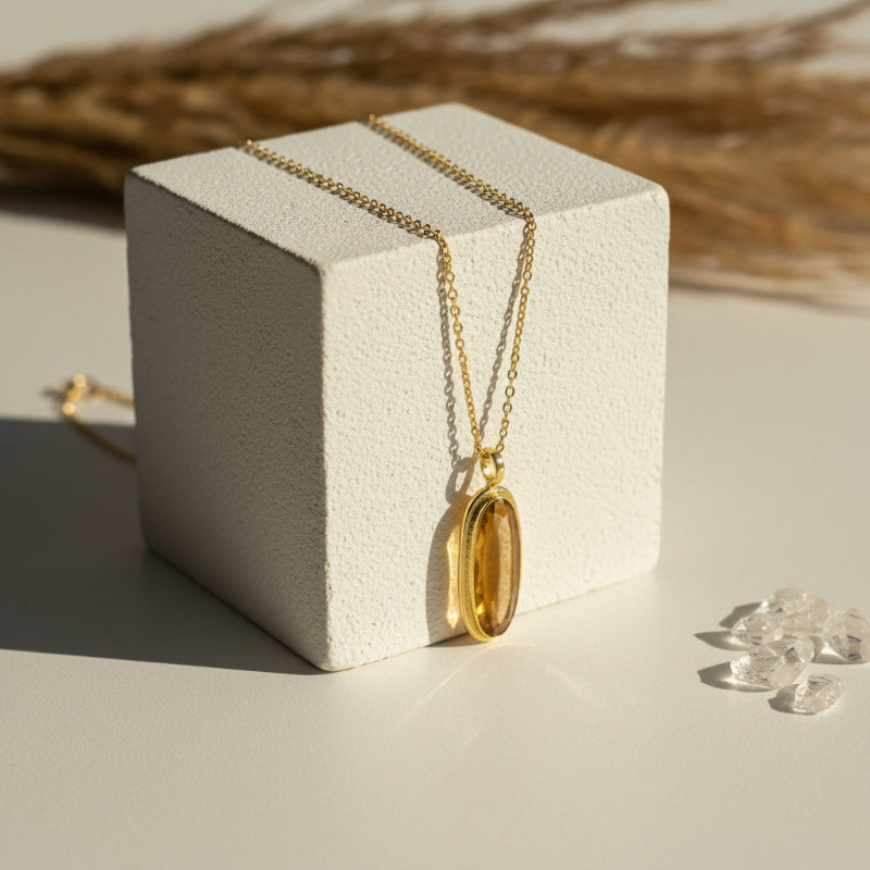 Natural citrine pendant necklace displayed on a wooden block — November birthstone
