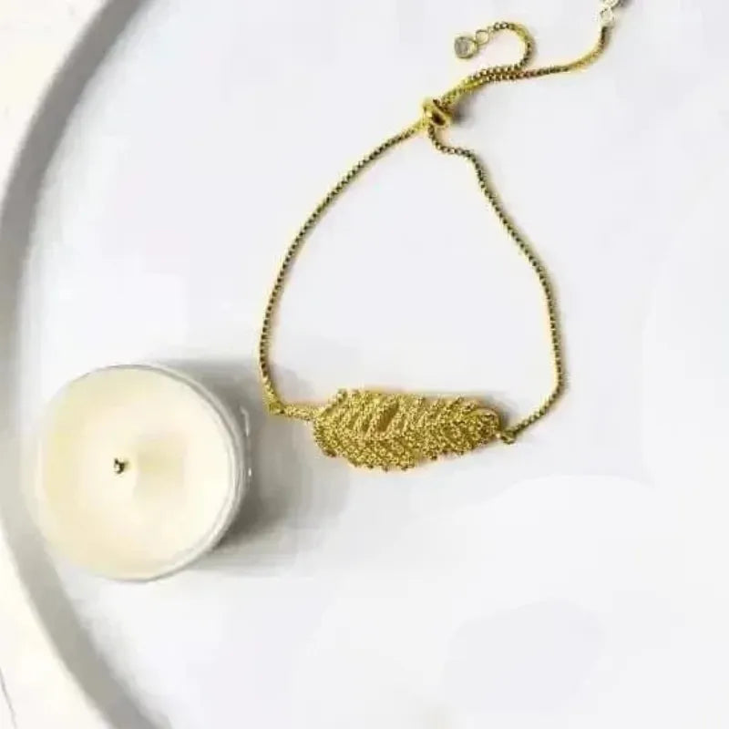 Gold crystal leaf charm bracelet with clear stone accents