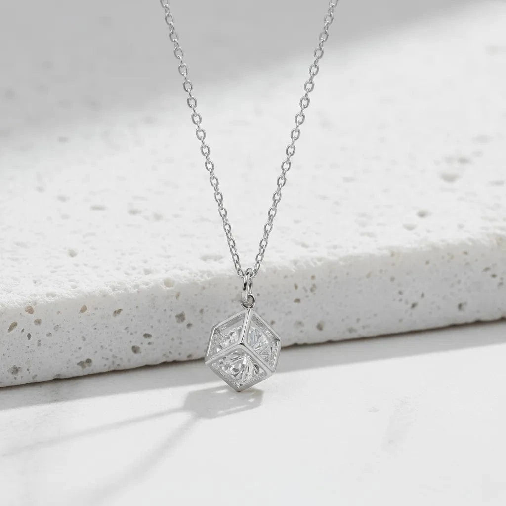 Silver geometric pendant necklace on a white background