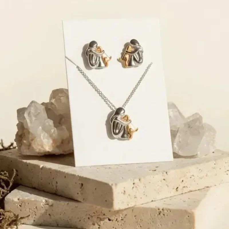 Jewelry set with necklace and earrings on a card, surrounded by crystals.