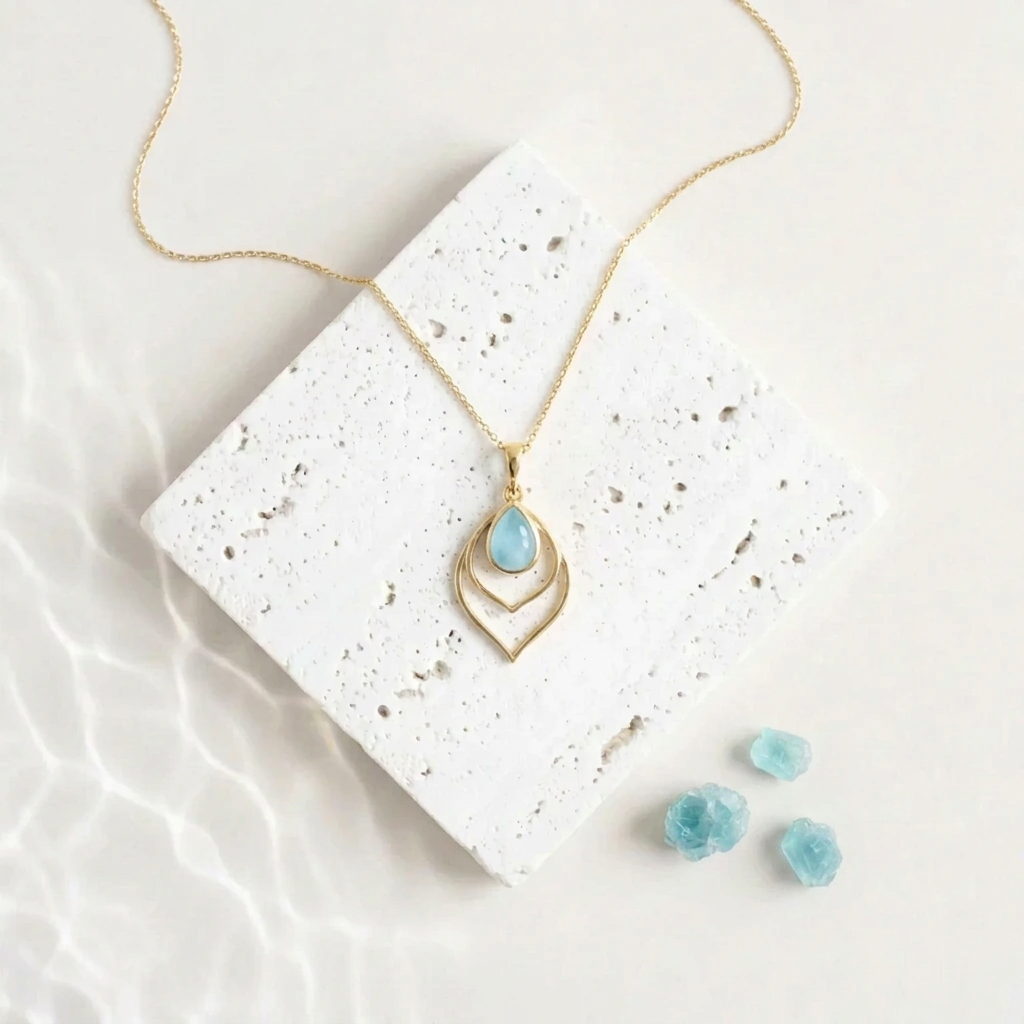 Gold Double Teardrop necklace with an aqua blue faceted glass drop, March birthstone colour