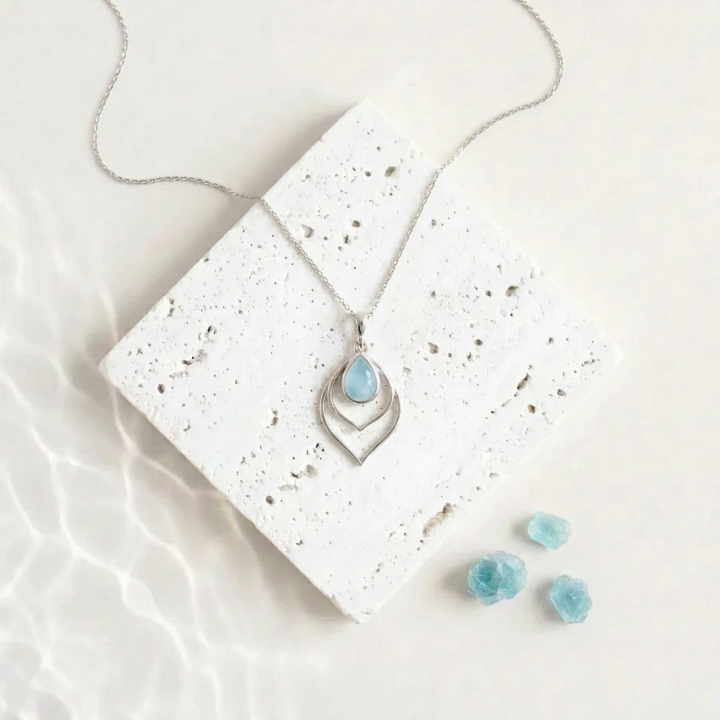 Silver Double Teardrop necklace with an aqua blue faceted glass drop inside the open frame