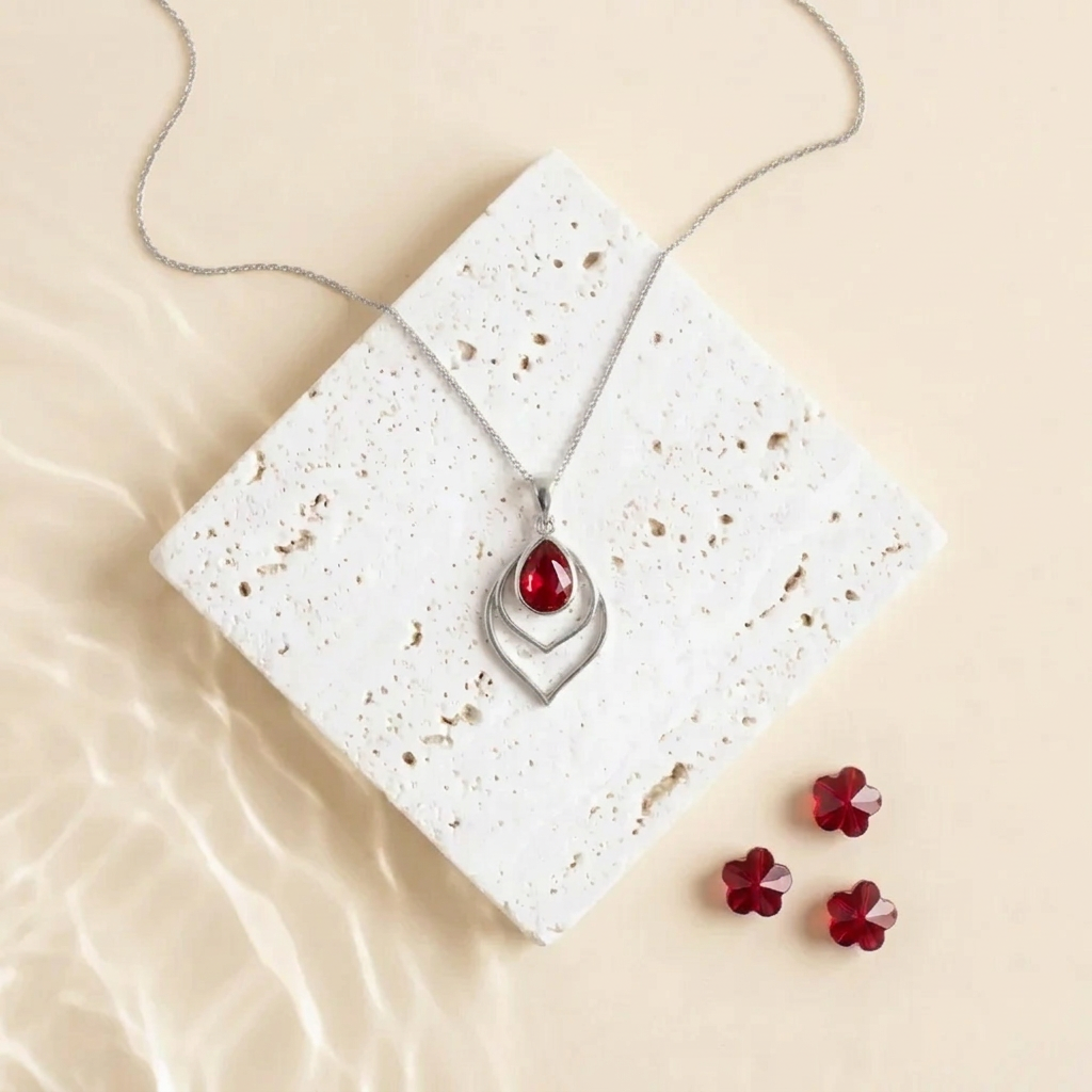 Silver Double Teardrop necklace with a red faceted glass drop, close view