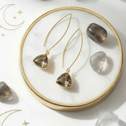 Gold plated Dusk Cleo drop earrings with smoky grey glass triangles