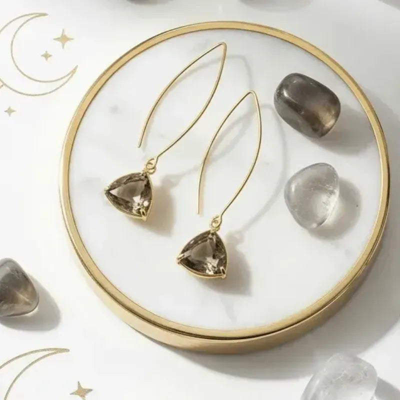 Gold plated Dusk Cleo drop earrings with smoky grey glass triangles