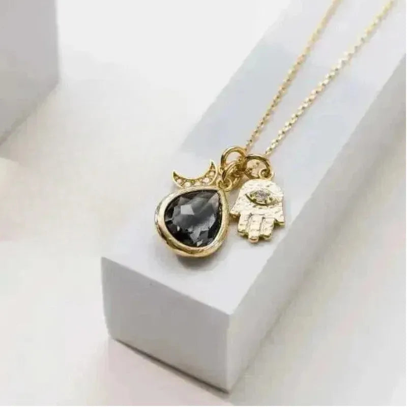 Dusk grey hamsa hand necklace in gold, protection symbol jewelry