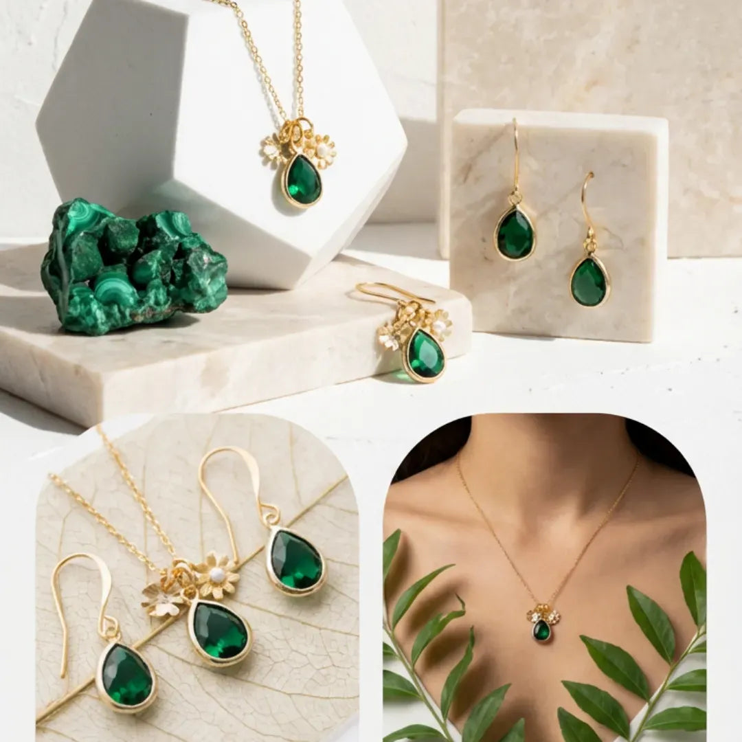 Green gemstone jewelry set with gold necklaces and earrings on a neutral background.