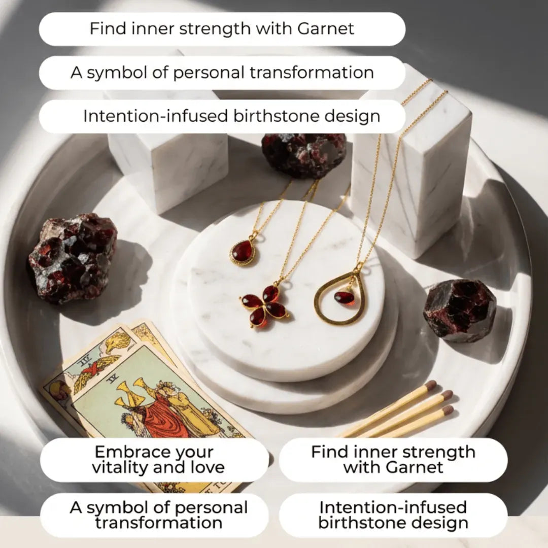 Jewelry set with garnet stones on a marble surface, accompanied by tarot cards and crystals.