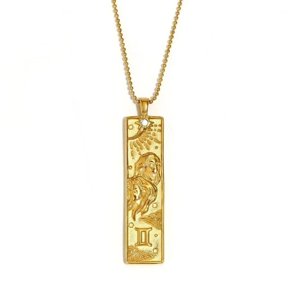 Gold pendant necklace with zodiac design on a white background