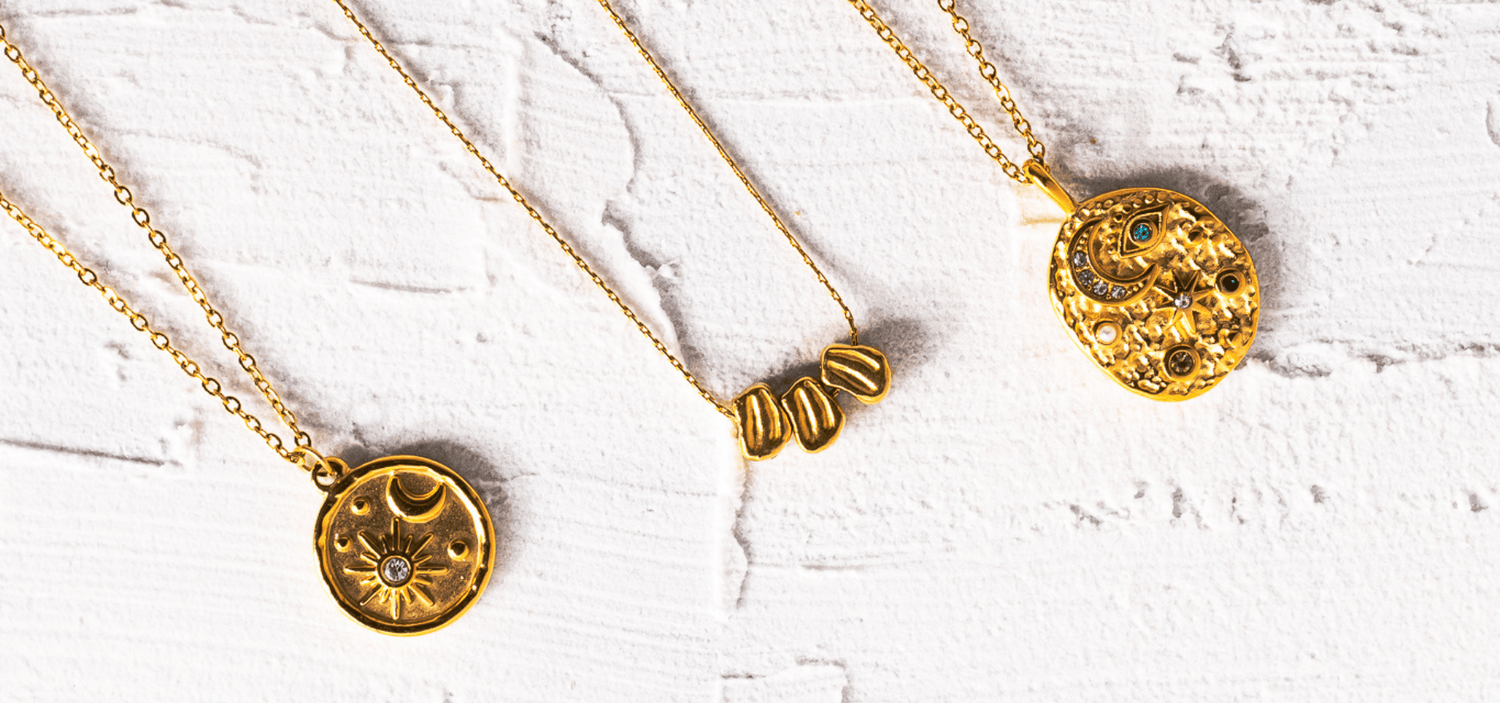 flat lay on white background with gold jewelry and text