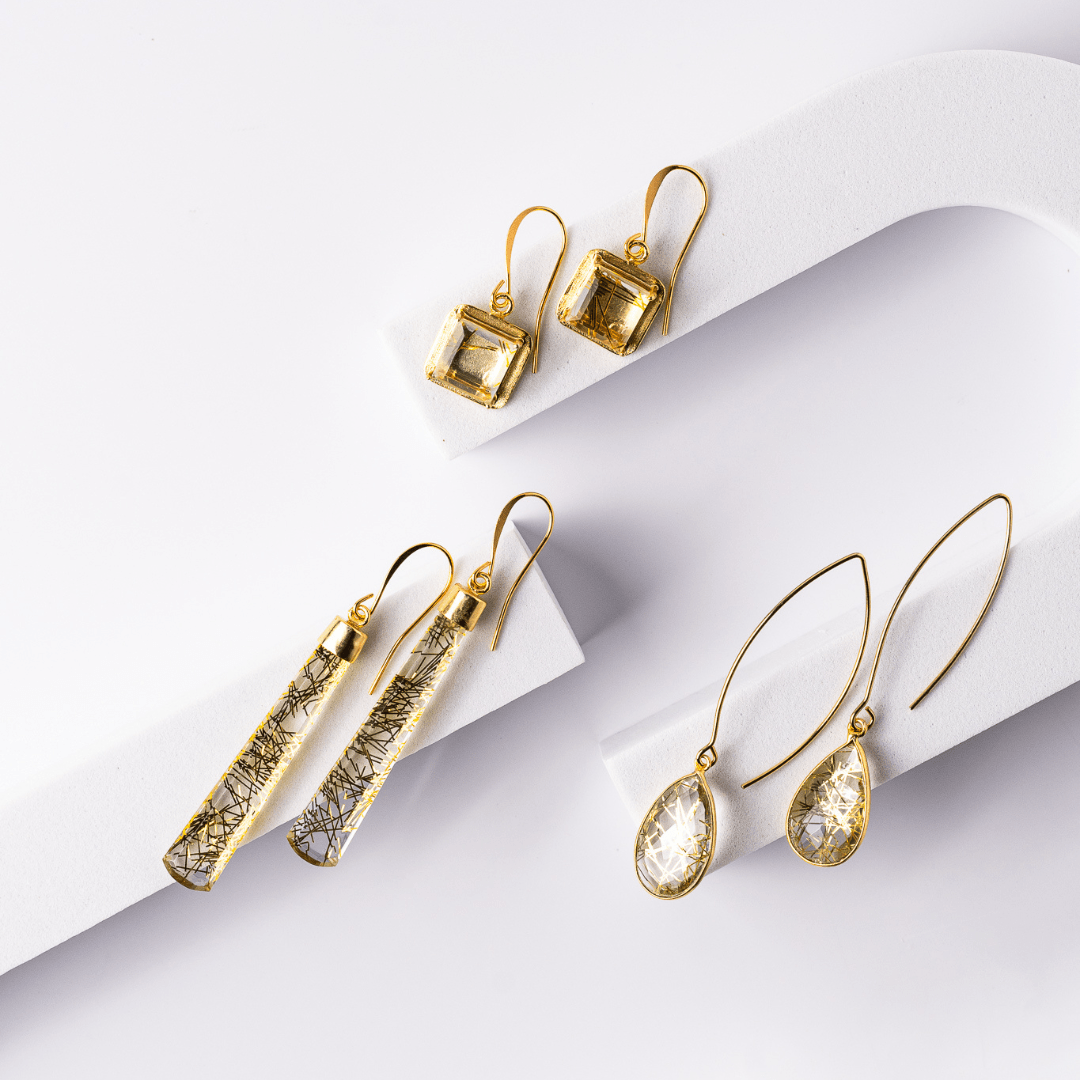Set of gold earrings on a white background