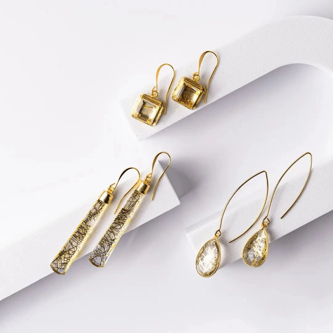 Set of gold earrings on a white background
