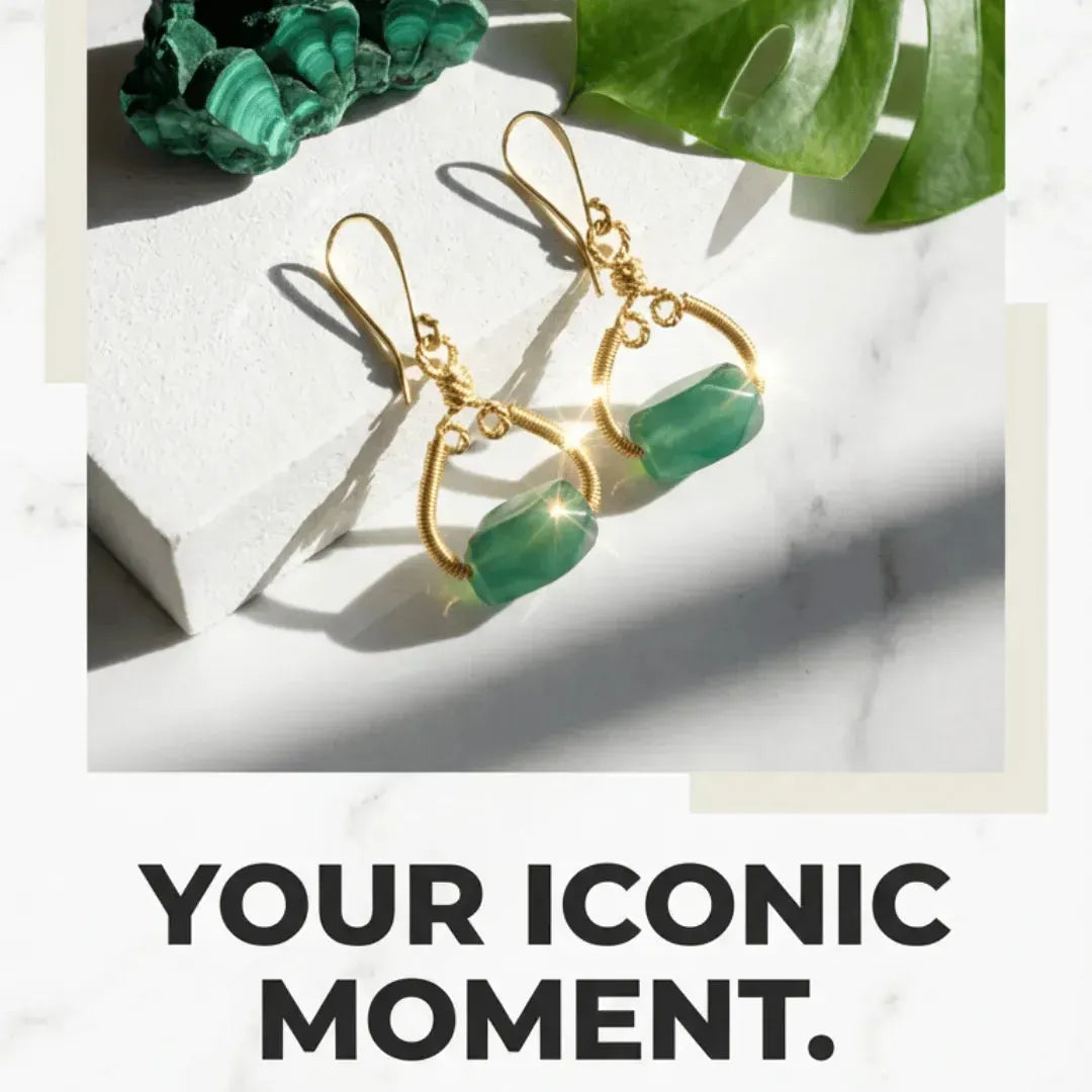 Gold earrings with green stones on a marble surface with text 'YOUR ICONIC MOMENT'.