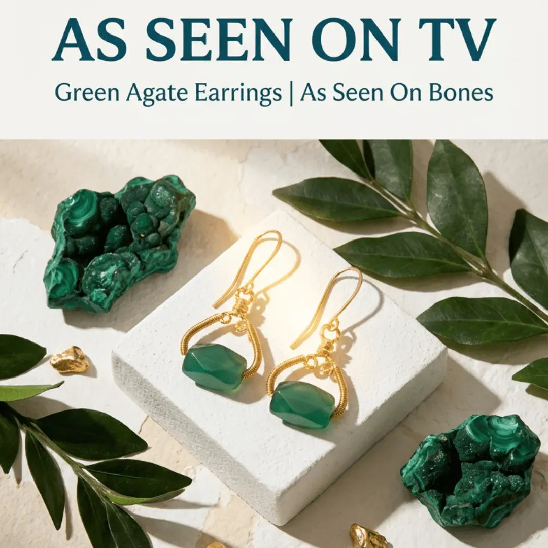 Green agate earrings with gold hooks on a white block, surrounded by green leaves, with text 'As Seen On TV' and 'Green Agate Earrings | As Seen On Bones'.