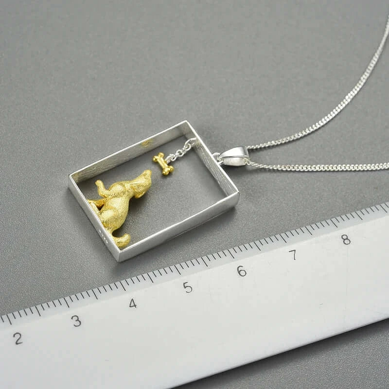 Sterling silver and gold dog portrait pendant, luxury pet jewelry by Mystic Soul, showcased with a ruler for size reference.