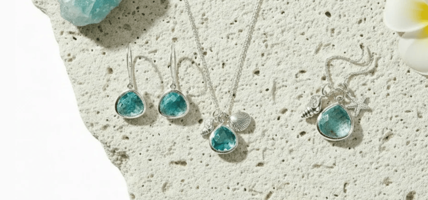 Jewelry set with blue gemstones on a textured surface