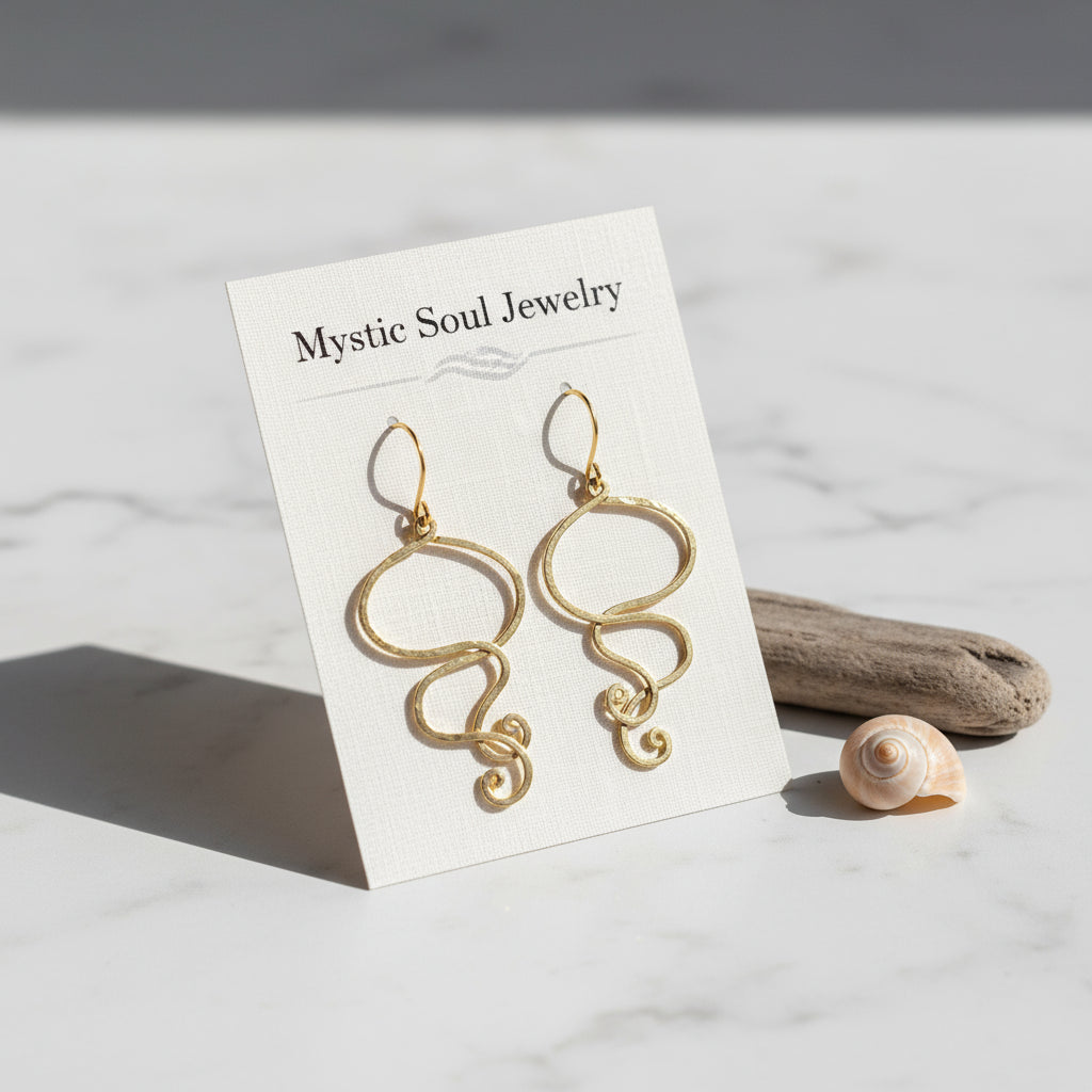 Gold earrings with intricate designs on a white background