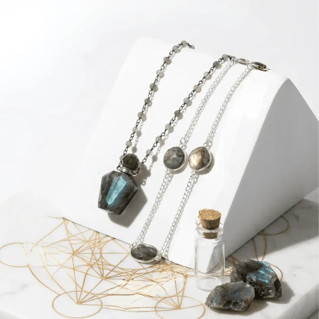 Necklace with pendant and stones on a white surface with geometric design