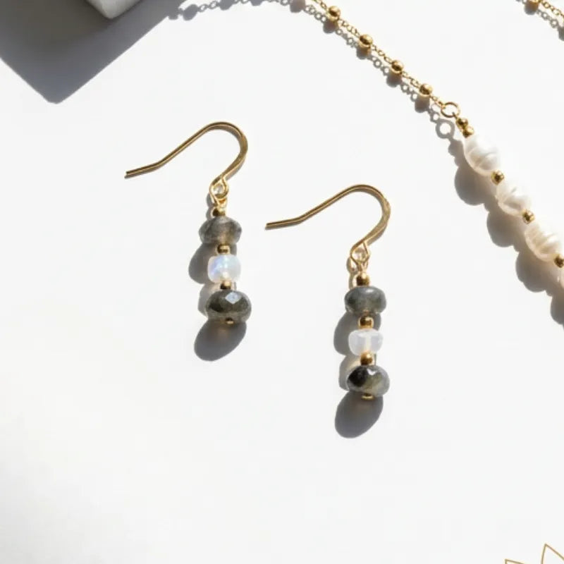 Pair of beaded earrings with gold hooks on a light background