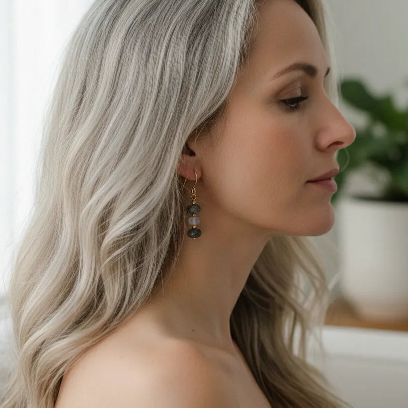 woman wearing gold labradorite, moonstone and pyrite drop earrings — one-of-a-kind crystal jewelry for grounding