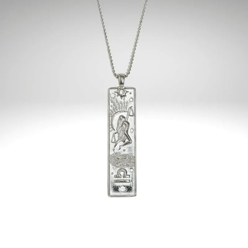 Silver pendant necklace on a light gray background