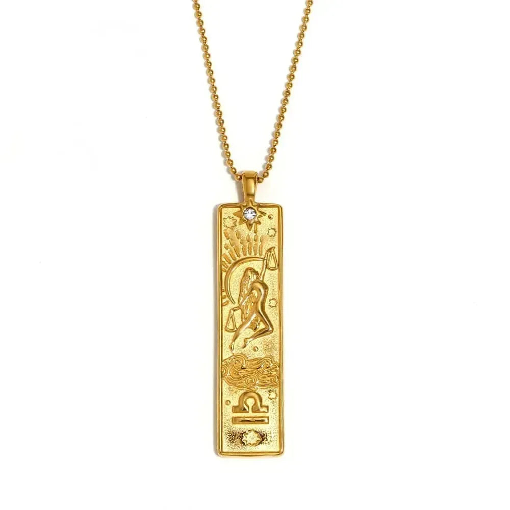 Gold pendant necklace with intricate design on a white background