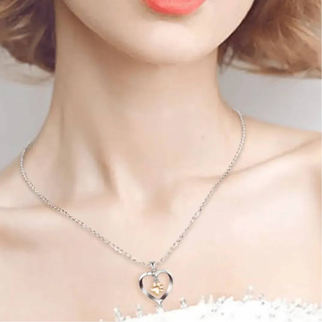 Silver necklace with a heart-shaped pendant worn by a person