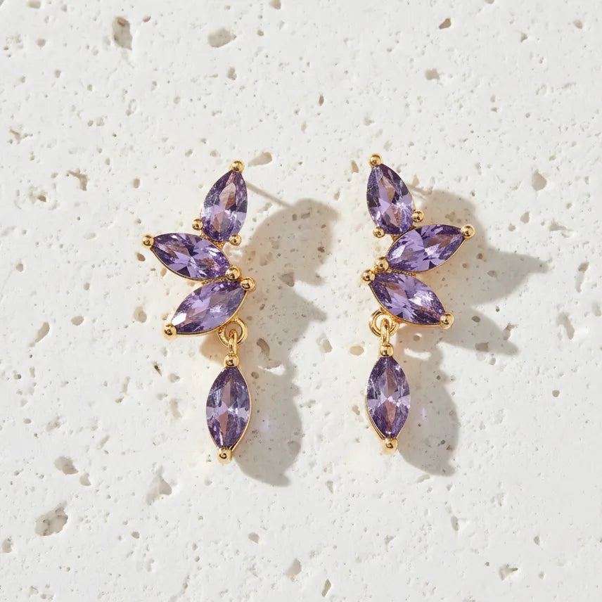 Purple gemstone earrings with gold accents on a white background